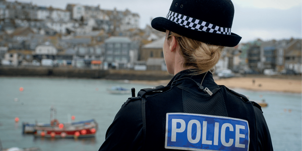 Back of female officer looking across a St Ives bay