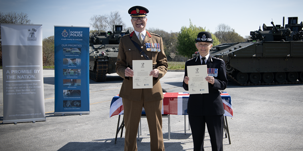 Colonel John Godfrey and Chief Constable Amanda Pearson smiling with signed covenant