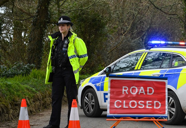 Female Police Officer guarding a road closure