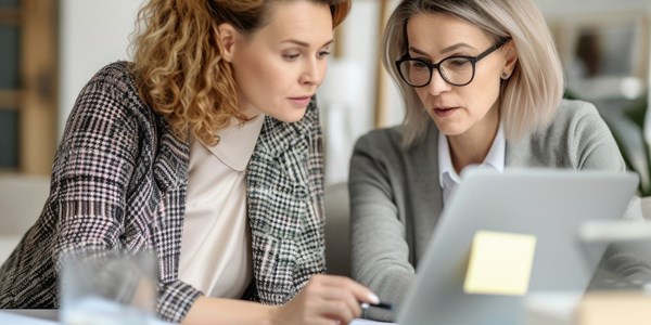 Two women looking at a laptop